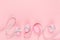 Fashion easter background - pink eggs with grey ribbon quaint stripes as border on pastel pink color.