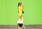 Fashion elegant young woman in yellow suit clothes with handbag