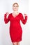 Fashion female in red lace dress standing alone. plus size blonde woman with short hair and chubby body posing in evening middle l