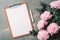 Fashion feminine blogger concept. Feminine workspace with notebook, clipboard, paper, pink peony, eucalyptus flower on marble