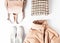 Fashion flat lay with long beige puff, scarf and sneakers on white background