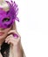 Fashion girl with carnival mask and purple ring over white background. Halloween