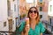 Fashion girl eating ice cream on bridge channel in Venice, Italy