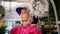 Fashion girl in headscarf and hat looking decoration in souvenir shop. Portrait beautiful young woman in hat and pink