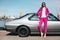 Fashion girl standing next to a retro sport car