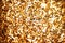 Fashion golden sequins, sparkling sequined textile. Gold background.