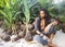 Fashion guy with dreadlocks in tropical coconut palms smiling