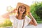 Fashion, happiness and lifestyle concept - beautiful woman in hat enjoying summer outdoors.