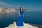 Fashion Happy beautiful woman in long dress over blue sky, outdo