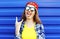 Fashion hipster cool girl in sunglasses and colorful clothes having