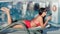 Fashion lady in swimsuit relaxing on deck chair listening music using smartphone and earphones