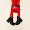 Fashion legs in platform party boots and red leather clutch and leggins on minimal background. Stylish clubbing 90s fashion