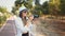 Fashion look, pretty cool young woman model with camera wearing a elegant hat, outdoors over. Photo of happy excited