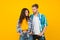 Fashion look of romantic couple in love yellow background, relationship