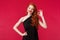 Fashion, luxury and beauty concept. Portrait of satisfied coquettish pretty redhead woman in elegant black dress