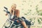 Fashion model biker girl on a motorcycle - old retro fashioned t