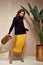 Fashion model brunette hair wear yellow silk dress skirt black top sandals high heels accessory bag clothes for date party walk