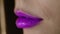Fashion model lips. Purple lipstick on girl lips. female mouth closeup