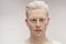 Fashion model male on white. Handsome albino guy closeup.