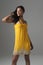 Fashion Model Standing In Bright Yellow Dress