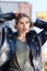 Fashion model wearing massive silver earrings posing in beret