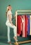 fashion model. woman choose outfit in wardrobe. showroom. shopping in female boutique