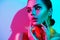 Fashion model woman in colorful bright lights with trendy makeup and manicure