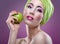 Fashion modell with beautiful pink makeup and green apple