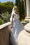 Fashion outdoor photo of gorgeous bride in luxurious wedding dress