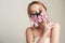 Fashion photo of a girl in a mask of flowers. Spring that we cannot breathe. Virus, pandemic, coronavirus, masked model