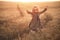 Fashion photo of a little girl in leopardprint dress, sunglasses and straw hat at the evening wheat field