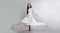 fashion photo of young girl in white dress flying tissue. Lightweight material.