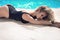 Fashion portrait of beautiful tanned woman with blond hair in elegant black bikini relaxing beside blue swimming pool