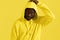 Fashion portrait black man in yellow hoodie on color background