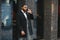 Fashion portrait of a handsome young African American business man walking outdoors in a casual pose