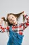 Fashion portrait of a little girl. handsome kid posing in the studio. Children raised up hair