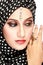 Fashion portrait of young beautiful muslim woman with black scar