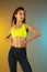 Fashion portrait of young fit and sportive woman on gradient background. Perfect body ready for summertime.