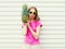 Fashion pretty cool girl in sunglasses with pineapple over white