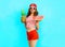 Fashion pretty slim smiling woman is holding a pineapple and a slice of watermelon