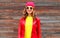 Fashion pretty smiling woman wearing a red leather jacket hat in autumn over wooden