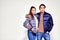 Fashion shot. Couple of young people in winter clothes posing at studio. Autumn and winter clothes
