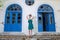 Fashion slim woman standing against old destroyed store