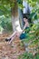 Fashion slim woman wearing green strapless short dress sitting sidewalk,