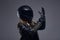 Fashion, sport, extreme. Portrait of a biker girl wearing leather racer costume and protective helmet putting on gloves