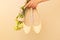 Fashion - spring footwear for woman. Pastel yellow ballet flats shoes and flowers on beige