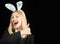 Fashion studio photo of beautiful girl with blond hair with bunny ears. Hunting eggs. Rabbit woman wearing ears