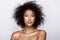 Fashion studio portrait of beautiful african american woman with perfect smooth glowing mulatto skin, make up