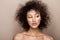 Fashion studio portrait of beautiful african american woman with perfect smooth glowing mulatto skin, make up