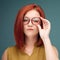 Fashion studio portrait of pretty young hipster red hair woman with bright sexy make up and glasses , wearing stylish